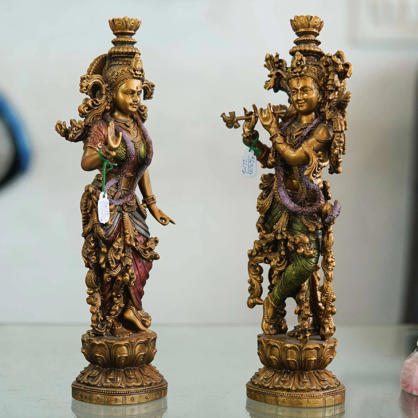 Pair of Brass Statues: Man Playing Flute and Woman Holding Flower