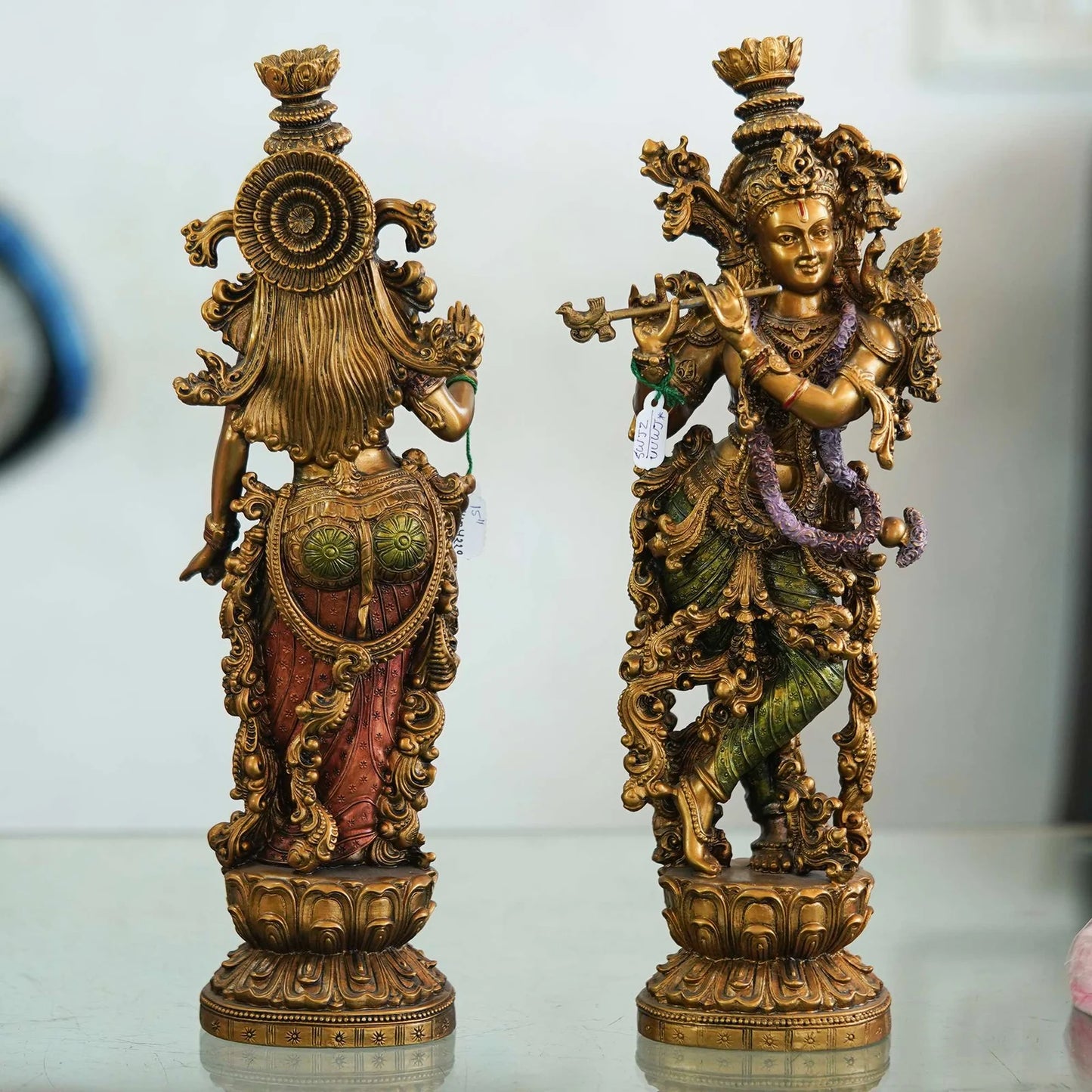 Pair of Brass Statues: Man Playing Flute and Woman Holding Flower