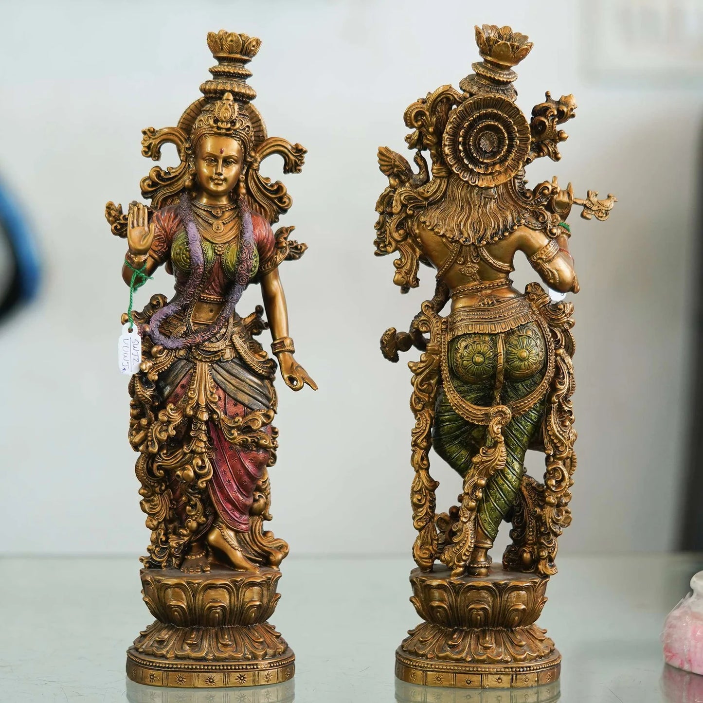 Pair of Brass Statues: Man Playing Flute and Woman Holding Flower
